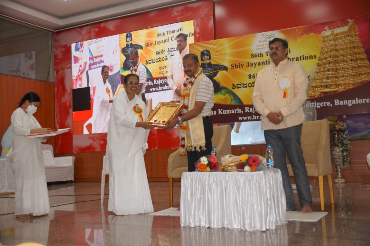Rajyogini Ambika Didi presenting Godly Gift to Shri Vasanth SH