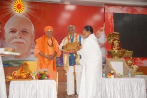 Rajyogini Ambika Didi presenting Godly Gift to Shri G.H Hanneradumath